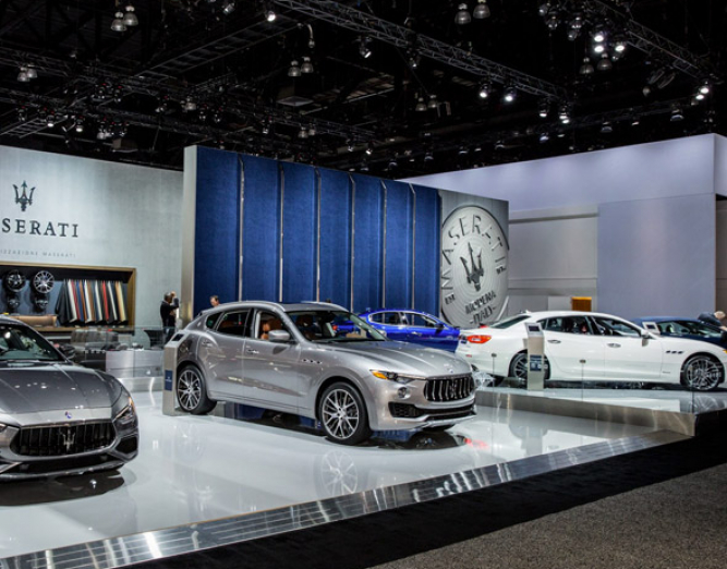 Luxury cars displayed on elevated platform