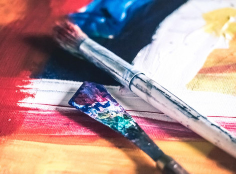 Paintbrushes on a painted canvas