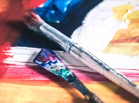 Paintbrushes on a painted canvas