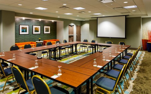 event space prepared for meeting with drop down projection screen