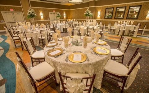 event space with round table decorated with white adornments