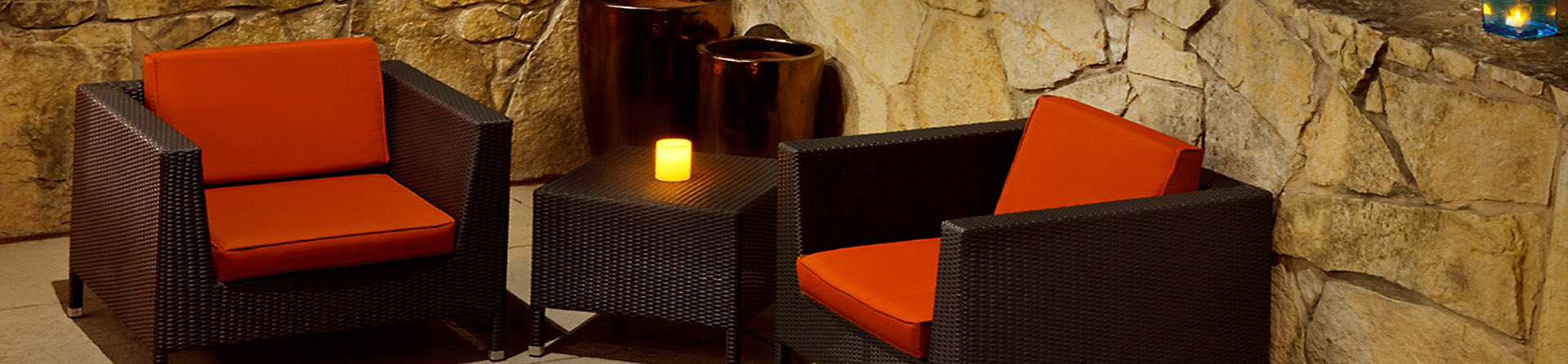 close up of outdoor furniture with orange cushions