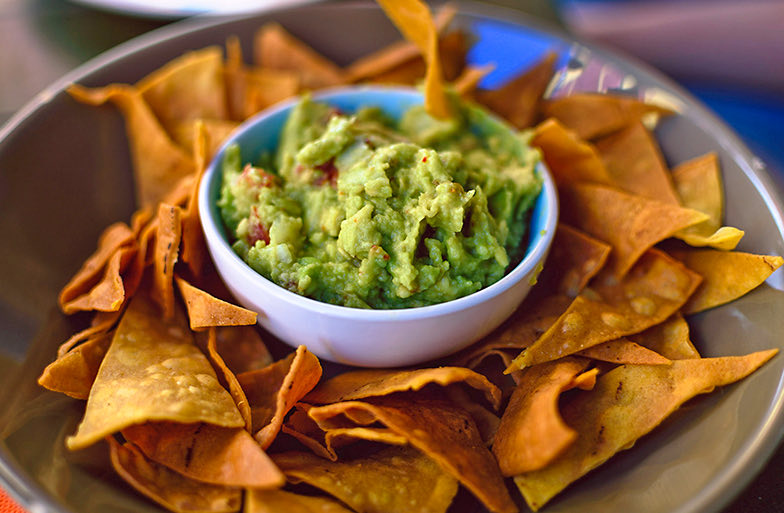 overhead view of chips and guac