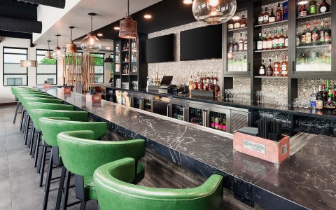 internal view of an empty bar with green seatings 