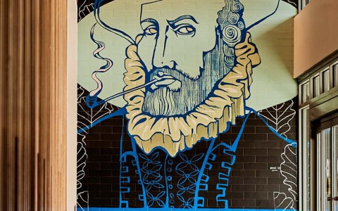 mural inside lobby of a cartoon of Sir Raleigh