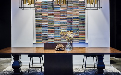 lobby desk in front of an art piece made of multiple stacks of books