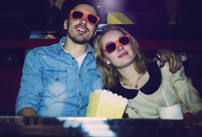 couple in orange glasses at movie theater