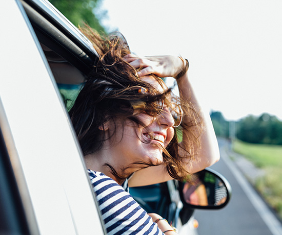 a woman looking out of a car window