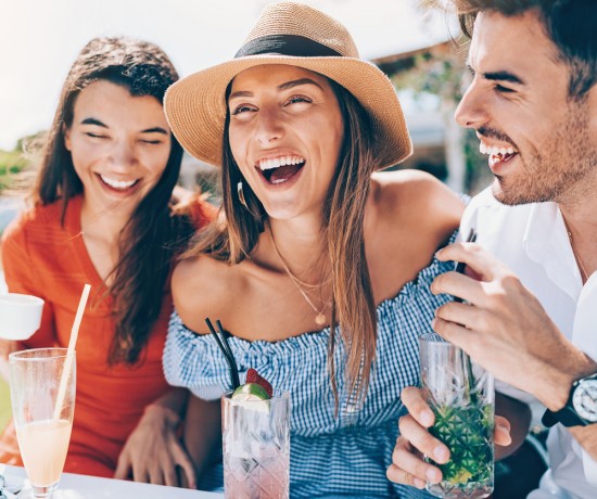 friends laughing enjoying drinks