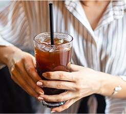 woman drinking an ice coffee