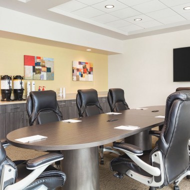 a boardroom with large chairs. 