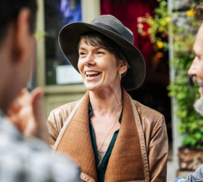 a woman smiling and talking