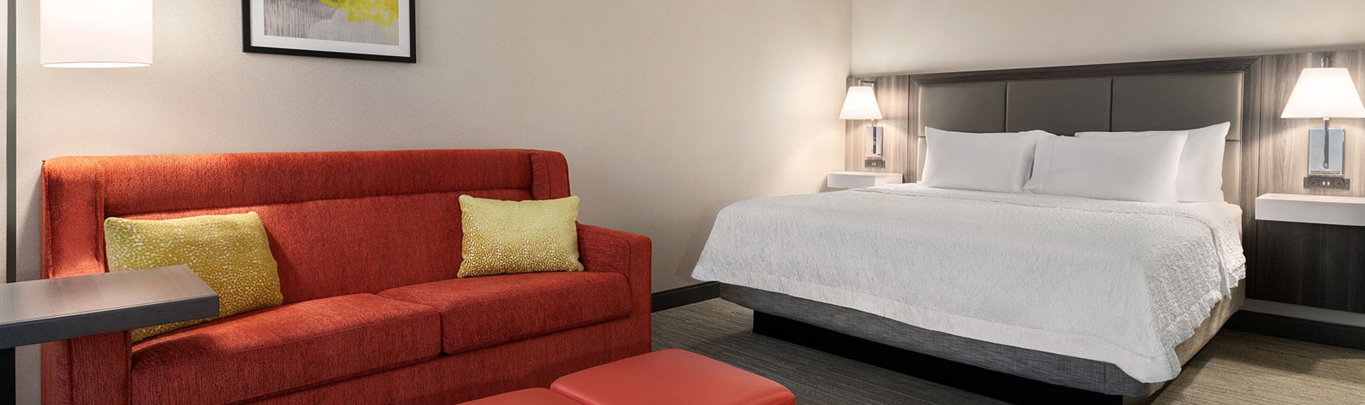 a guest room with a white bed and sitting area