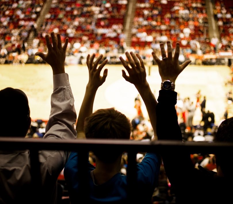 People on bleachers for basketball game