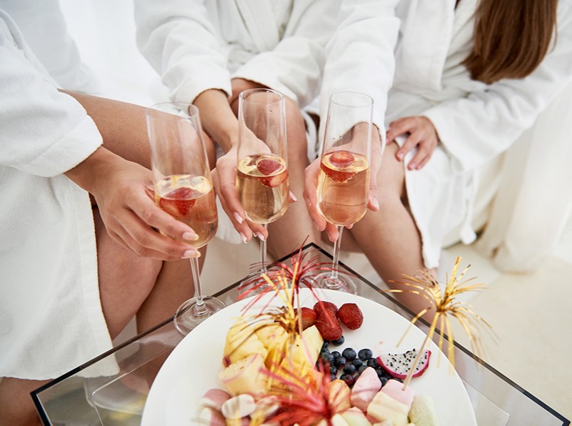 3 girls with Champagne and a fruit platter