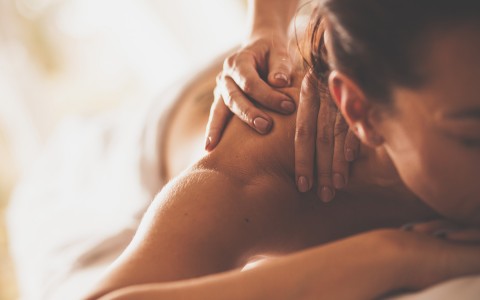 view of a woman having a shoulder massage at the Spa