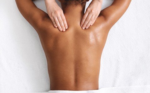 Woman getting a back massage at spa
