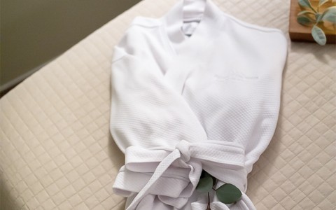 Spa robe on bed
