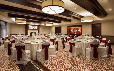 Events room setup with red accents and a fireplace 