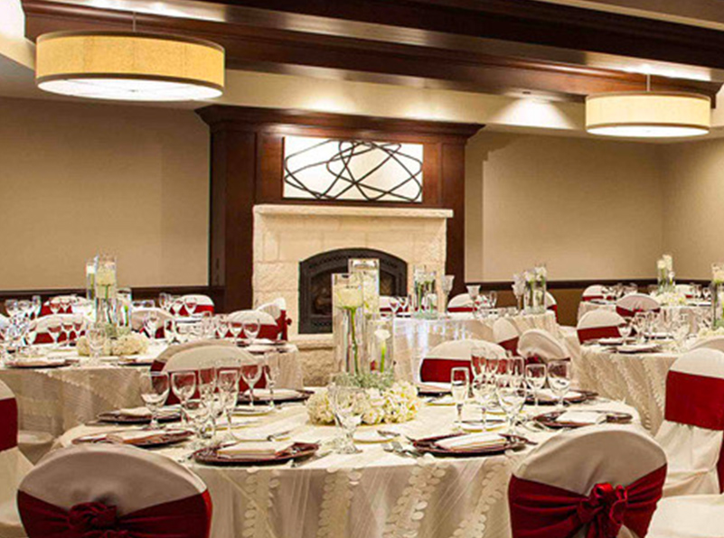 Events room setup with red accents and a fireplace