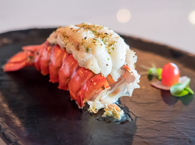 closeup view of seafood dish serve in a black plate