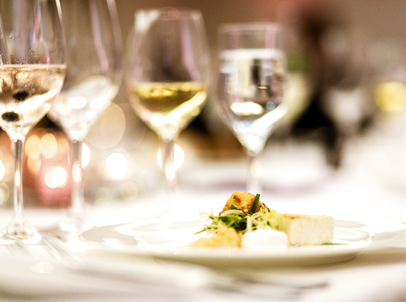 closeup view of a appetizer and a glasses of wine served in the table