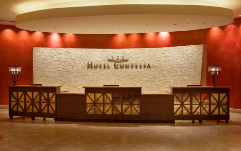 lobby desk and hotel name in the back