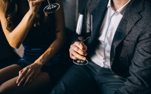 couple with wine on hands
