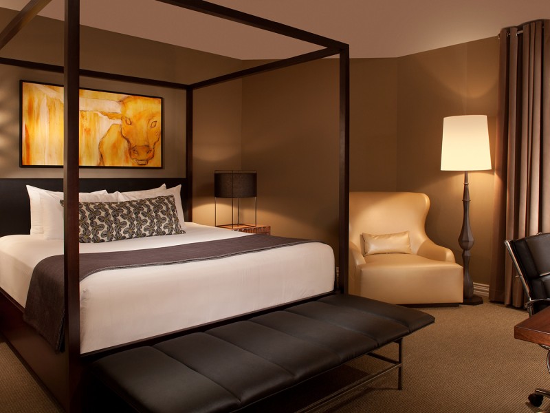hotel suite with king bed and dim lighting