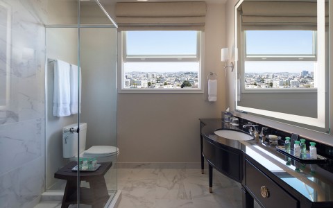 bathroom with black vanity and view of the city
