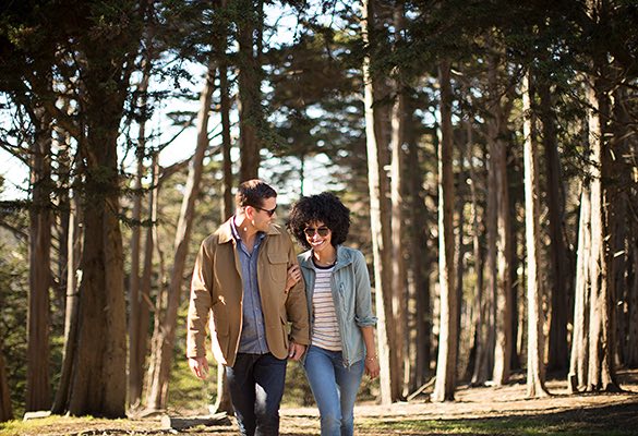 Couple walking through trees