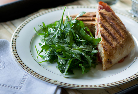 sandwich and salad on a round plate