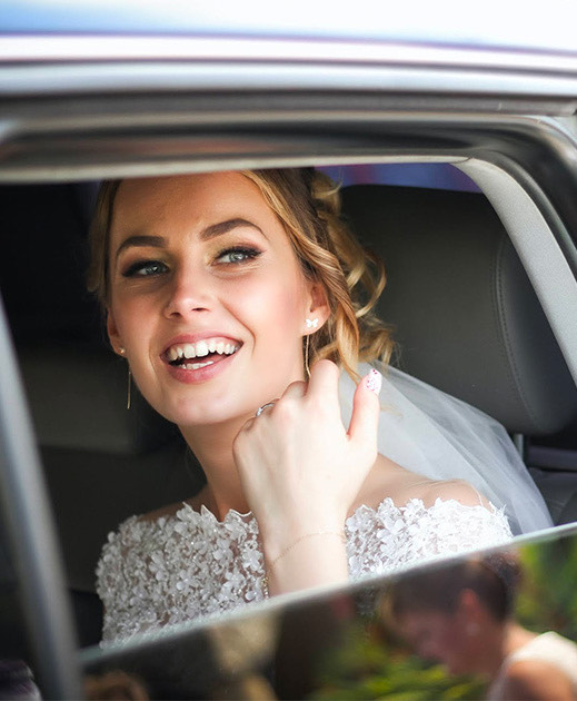 woman with blonde hair and light eyes, dressed in a wedding gown