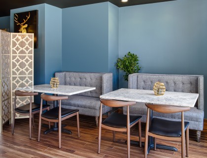 corner bar with gray couches with tables 