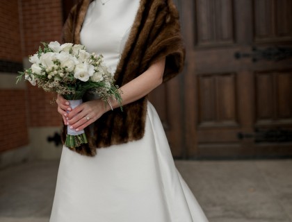 a bride holding a bouquet of white flowers