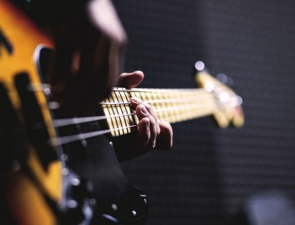 a closeup of a person playing a guitar