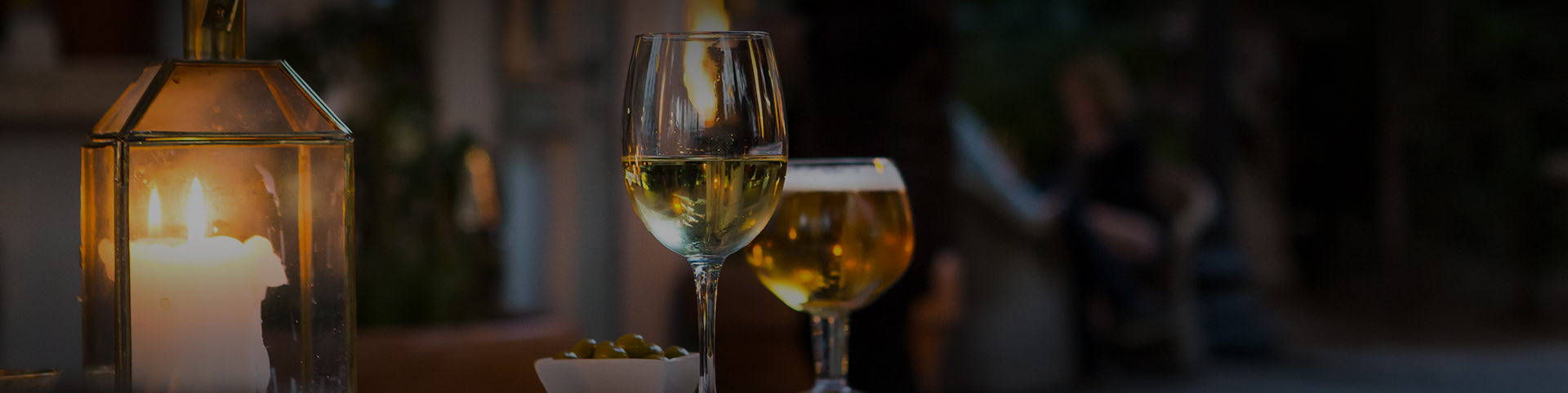 a glass of white wine and a glass of beer