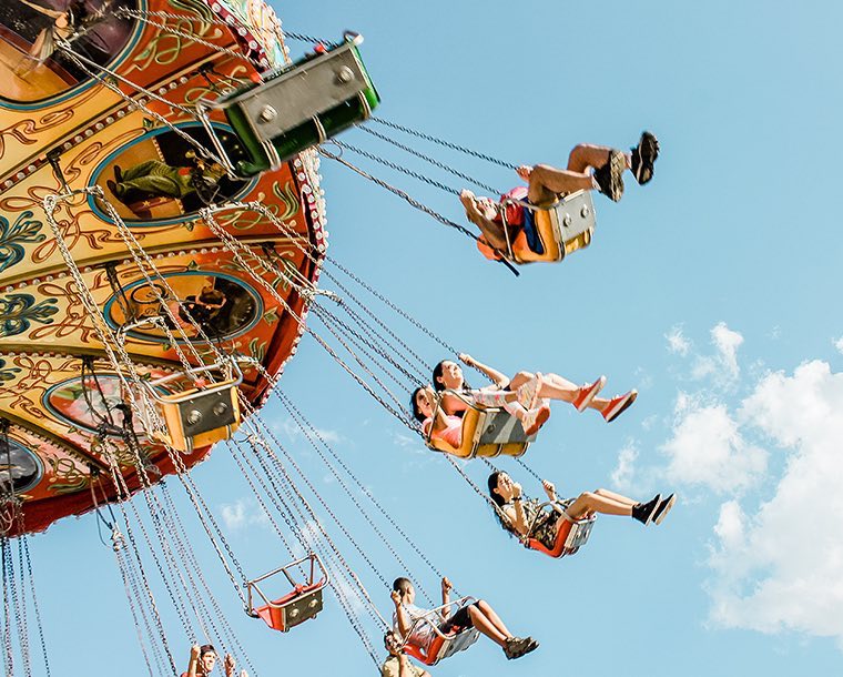 People riding on a spinning swings ride at an amusement park