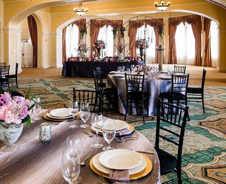 table setup with purple cloth and chairs in ballroom