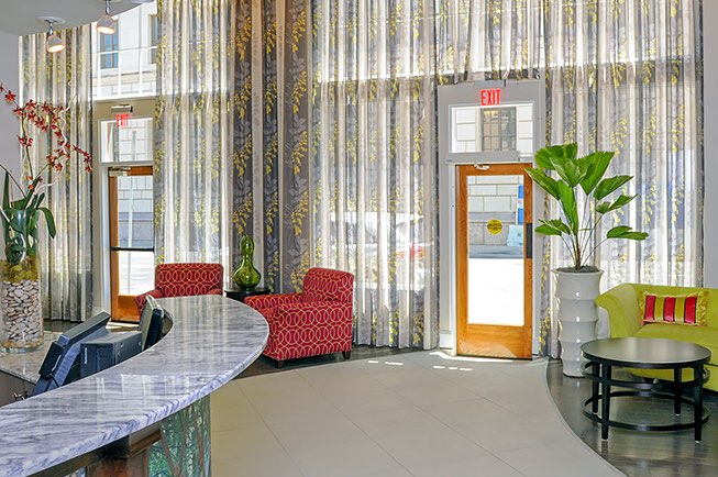 Hotel Gibbs lobby with two red chairs and front desk