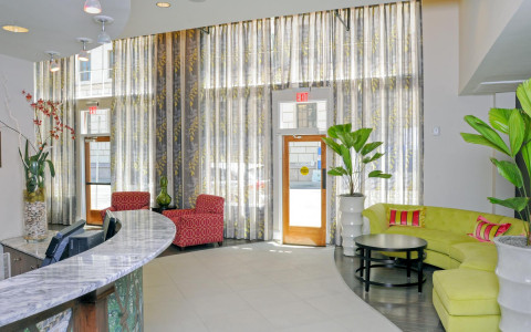 hotel gibbs lobby with green sofa and glass windows