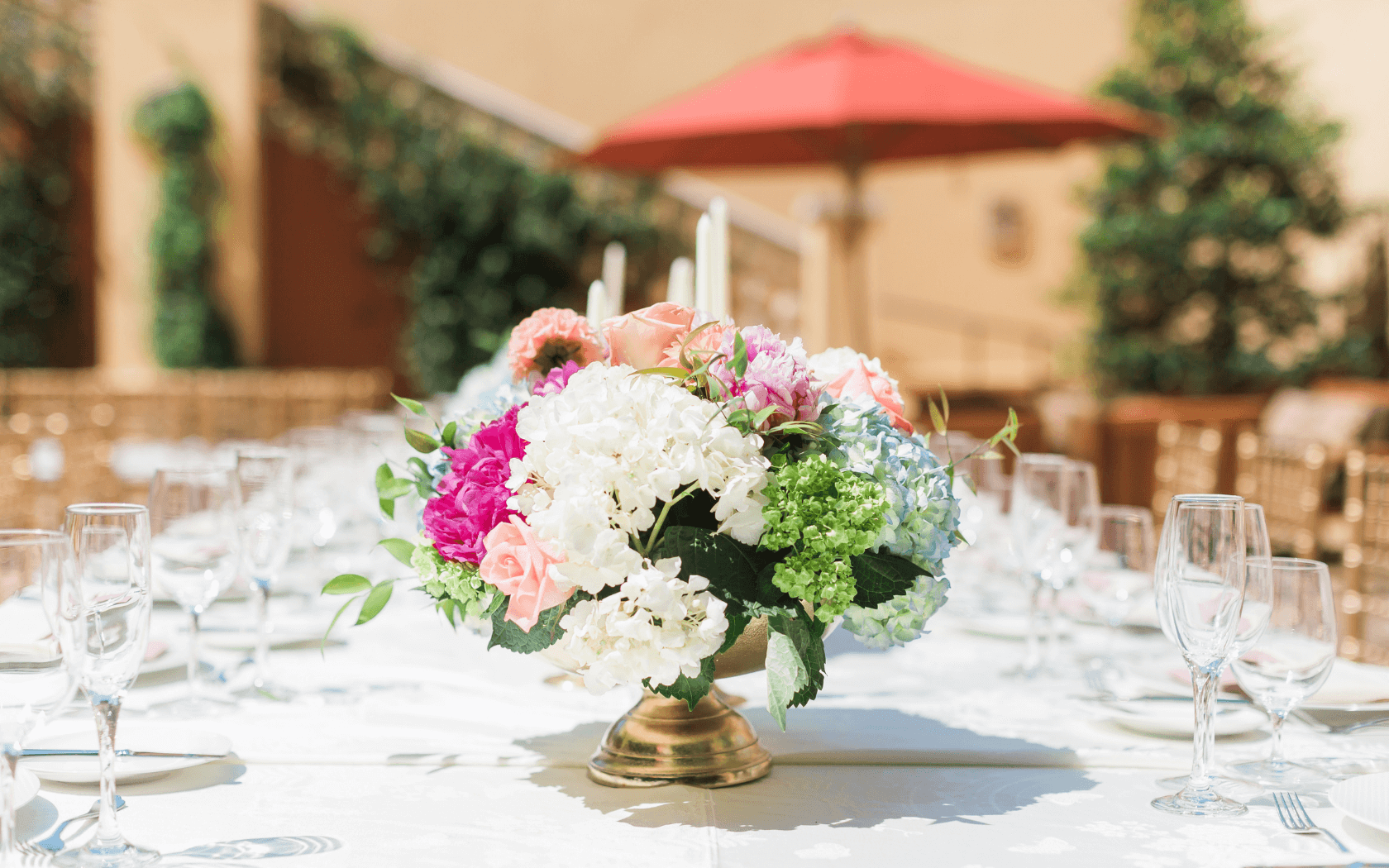 wedding floral arrangement on table outside in courtyard