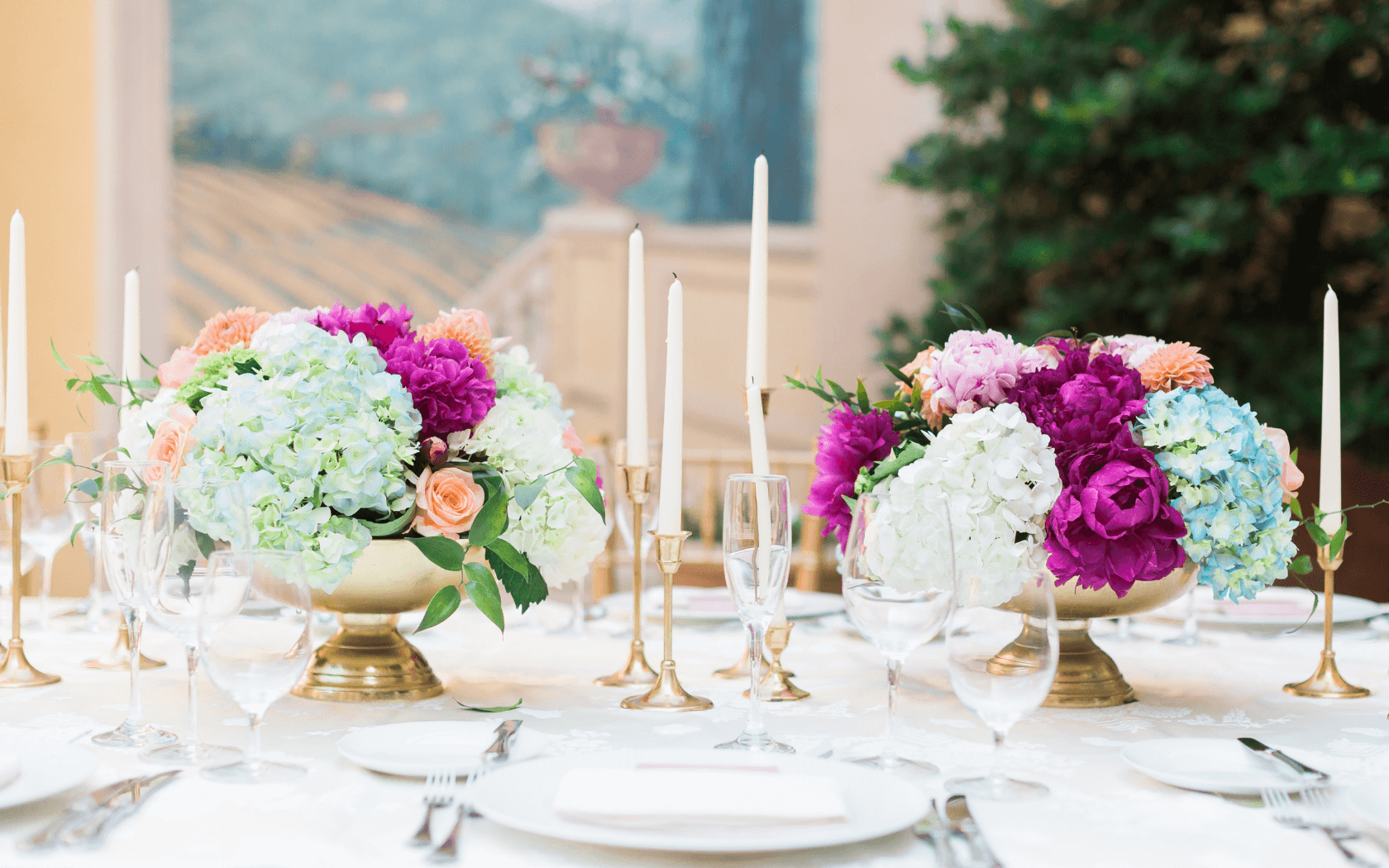 candlesticks and wedding floral arrangements on table