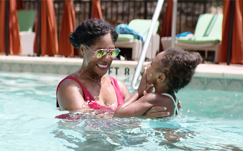 mother and daughter playing in the pool
