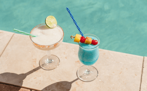 two frozen cocktails by the pool