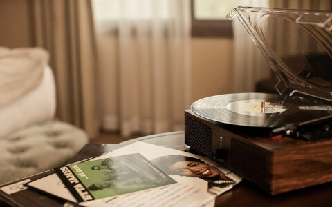 a record player sitting on the nigh stand 