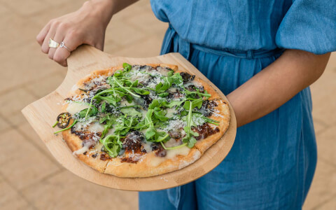 fresh baked pizza on a wooden board