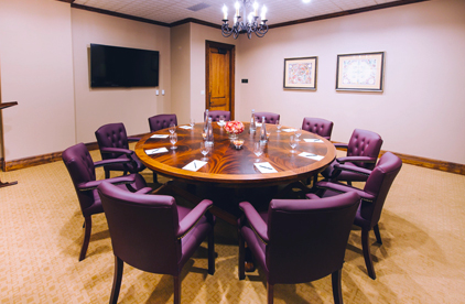 conference room with 10 burgundy chairs 