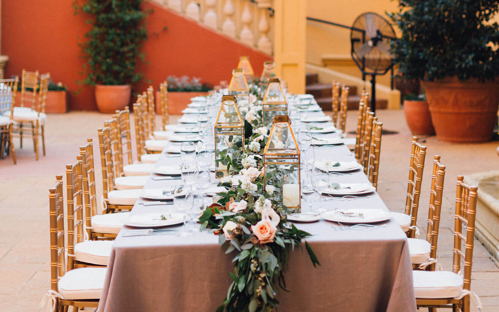 wedding table set up with floral decor and golden lanterns