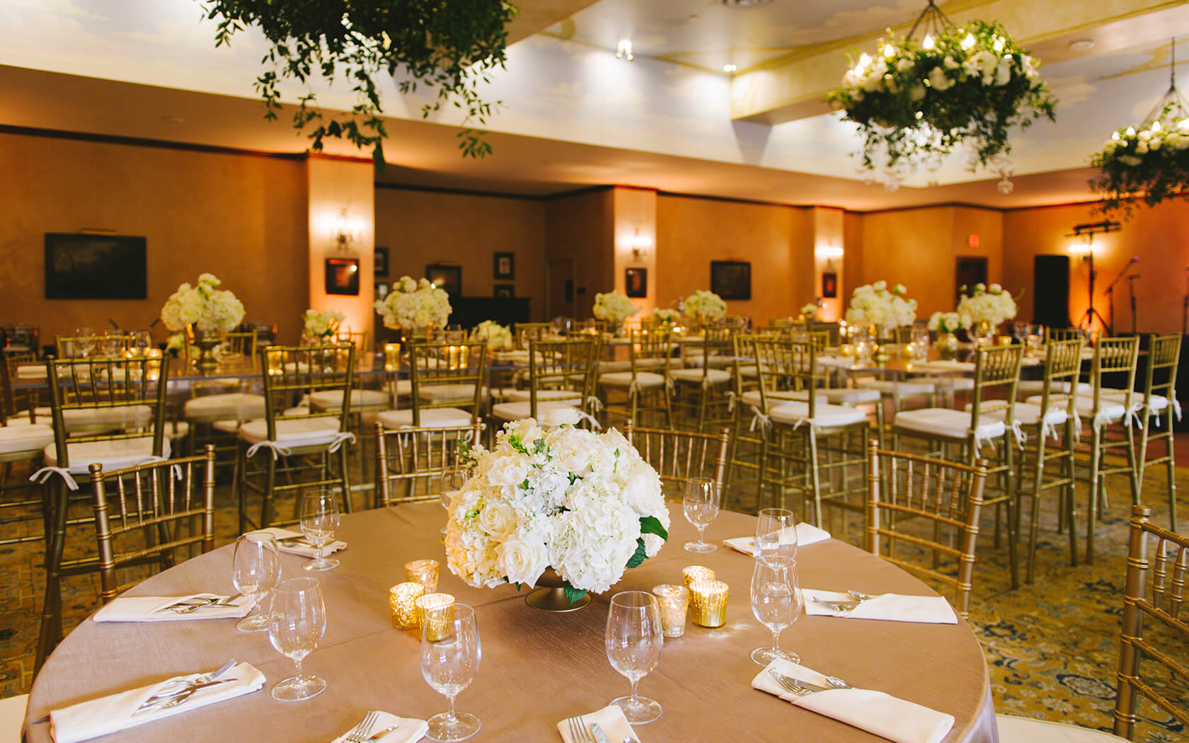 venue space decorated for a weddings and full of flowers